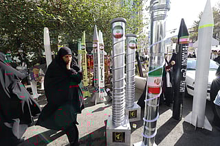 Models of missiles and nuclear centrifuges displayed during a rally outside the former US Embassy in Tehran on November 4, 2025, marking the 46th anniversary of the 1979 hostage crisis.