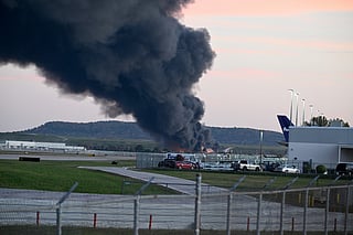 Fire and smoke mark where a UPS cargo plane crashed near Louisville Muhammad Ali International Airport on November 04, 2025 in Louisville, Kentucky.