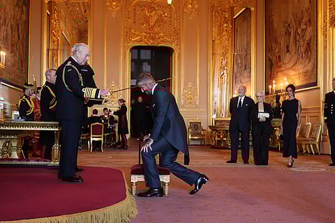 Sir David Beckham is made a Knight Bachelor by Britain's King Charles III during an Investiture ceremony at Windsor Castle, Berkshire, England, Tuesday, Nov. 4, 2025. 