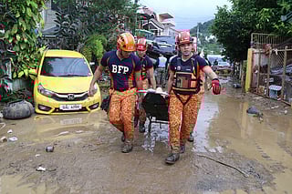 Rescue workers carry an injured resident as Typhoon Kalmaegi affects Cebu city, central Philippines on Tuesday, Nov. 4, 2025.