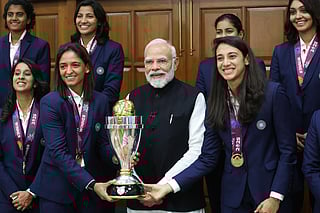 Prime Minister Narendra Modi holding the trophy poses for a group picture with the champions of the Women’s World Cup 2025, at his residence 7, LKM in New Delhi on Wednesday. 