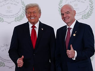 President Donald Trump and FIFA president Gianni Infantino pose for a photo in Sharm el-Sheikh, Egypt, Monday, Oct. 13, 2025. (Suzanne Plunkett, Pool Photo via AP)