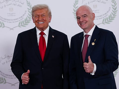 President Donald Trump and FIFA president Gianni Infantino pose for a photo in Sharm el-Sheikh, Egypt, Monday, Oct. 13, 2025. (Suzanne Plunkett, Pool Photo via AP)