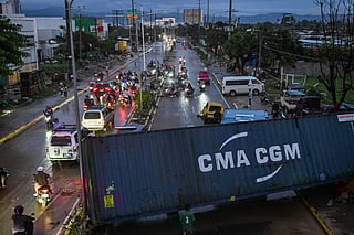 A shipping container blocks a road after it was swept away by the floods brought by Typhoon Kalmaegi in Mandaue City, Cebu province on November 5, 2025.