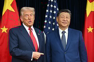 File photo of US President Donald Trump (L) and China's President Xi Jinping as they arrive for talks at the Gimhae Air Base, located next to the Gimhae International Airport in Busan on October 30, 2025.