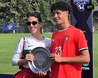 Cristiano Jr holding the trophy with his mother Georgina Rodriguez 