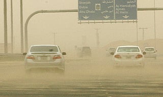 Motorists braving the sand storm and low visibility on Emirates road 