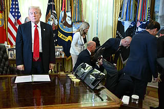 US President Donald Trump looks on after a man fainted during an announcement about weight-loss drugs in the Oval Office of the White House in Washington, DC on November 6, 2025.