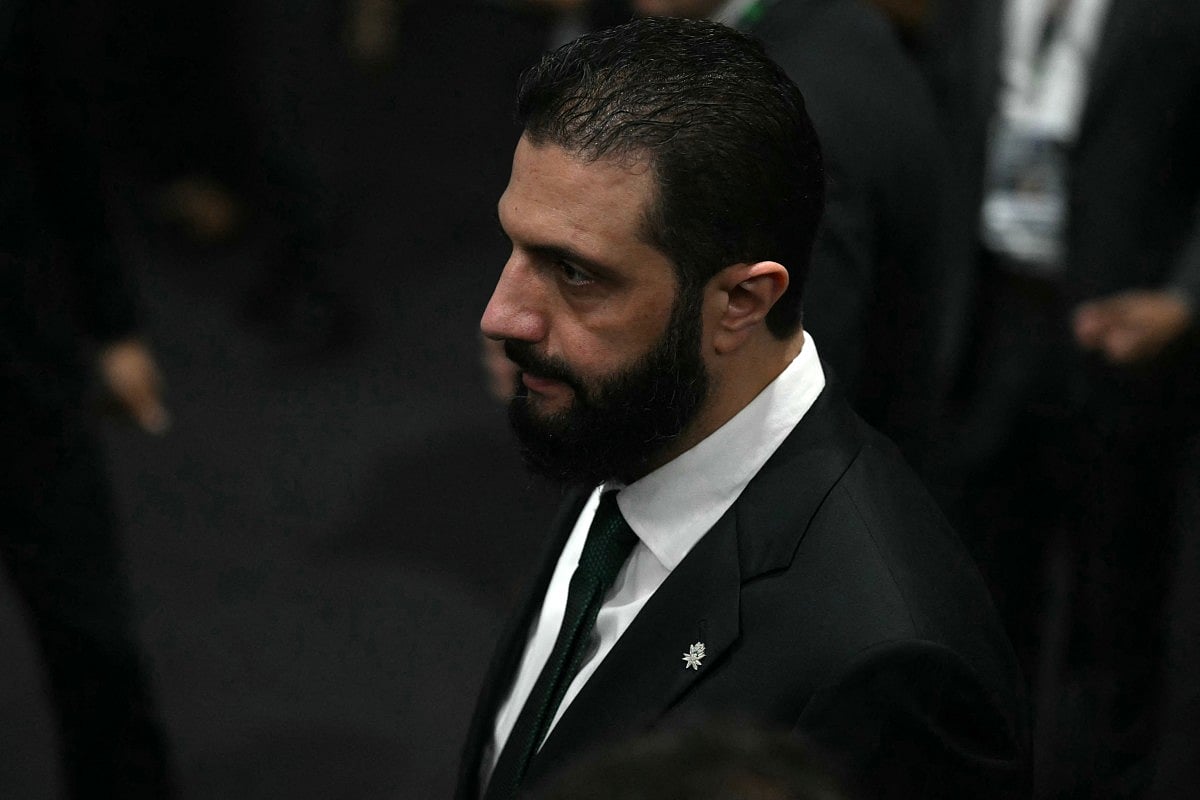 Syria's President Ahmad Al Sharaa walks on arrival at the General Plenary of Leaders in the framework of the COP30 UN Climate Change Conference in Belem, Para State, Brazil, on November 6, 2025.
