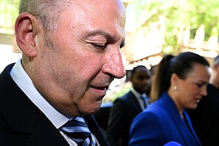 Tony Mokbel (L) -- one of the key figures in Melbourne's years-long gangland war -- walks from the Victoria Supreme Court of Appeal in Melbourne on November 6, 2025.