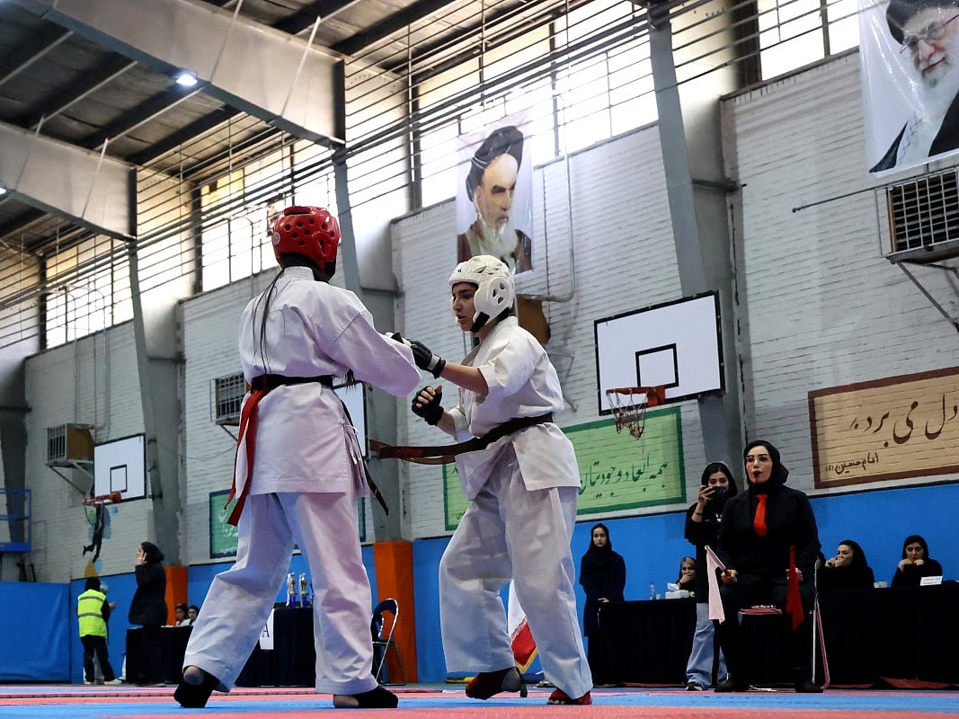 Two women fight during the women's karate competition, made-up of clubs and teams from around the Tehran province, in Tehran.