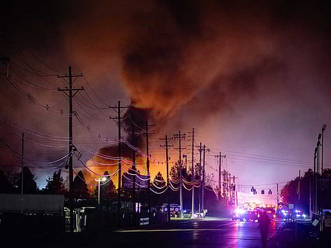 Plumes of smoke rise from the area of a UPS cargo plane crash at Louisville Muhammad Ali International Airport.