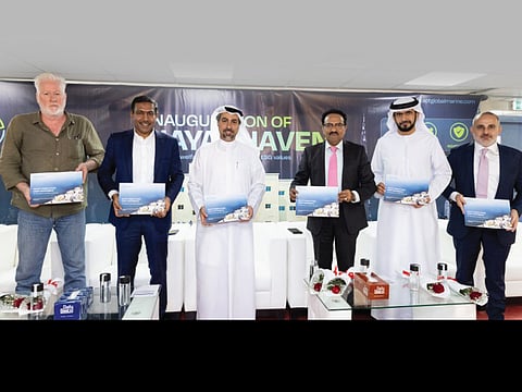 APT Global CEO and distinguished guests at the inauguration of Hayat Haven, proudly holding copies of the newly released ESG Report.