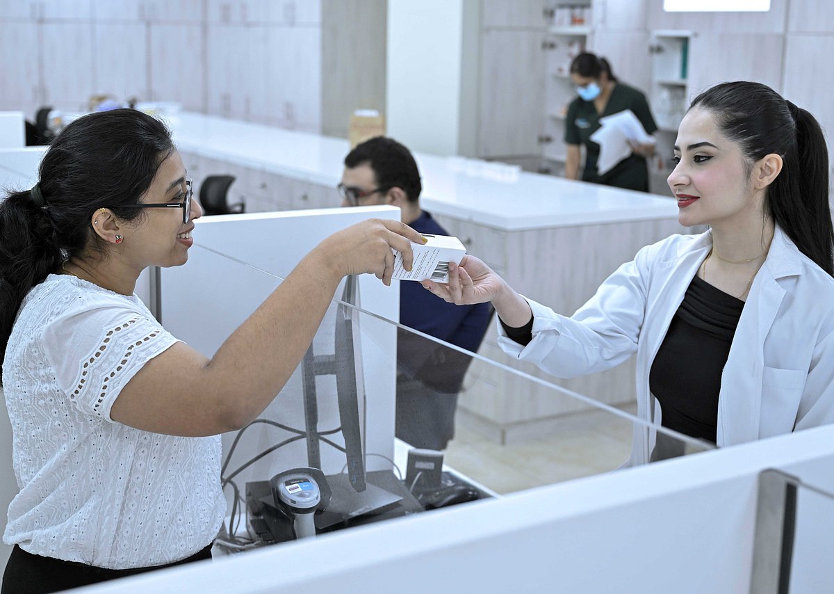 A patient buying an over-the-counter medicine from Burjeel Pharmacy.