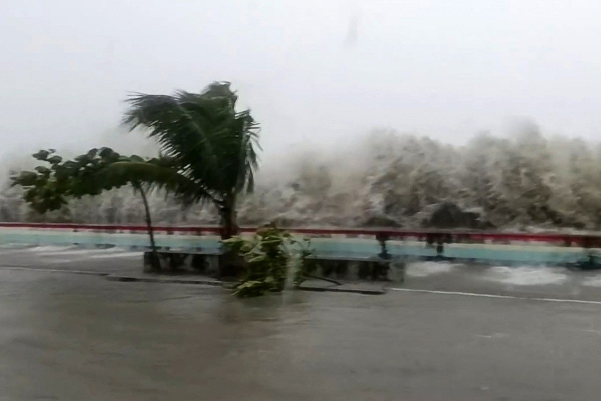 This screen grab made from UGC handout video footage courtesy of Facebook user Edson Casarino taken and released on November 9, 2025 shows storm surges sending waves hurtling over streets of Virac along the coast of Catanduanes island, as super typhoon Fung-wong approaches the Philippines.
