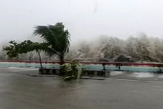 This screen grab made from UGC handout video footage courtesy of Facebook user Edson Casarino taken and released on November 9, 2025 shows storm surges sending waves hurtling over streets of Virac along the coast of Catanduanes island, as super typhoon Fung-wong approaches the Philippines.