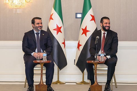 Syria's President Ahmed Al Sharaa listening to Syrian Foreign Minister Asaad Al Shaibani as they meet with representatives of Syrian-American organisations in Washington DC. on November 8.