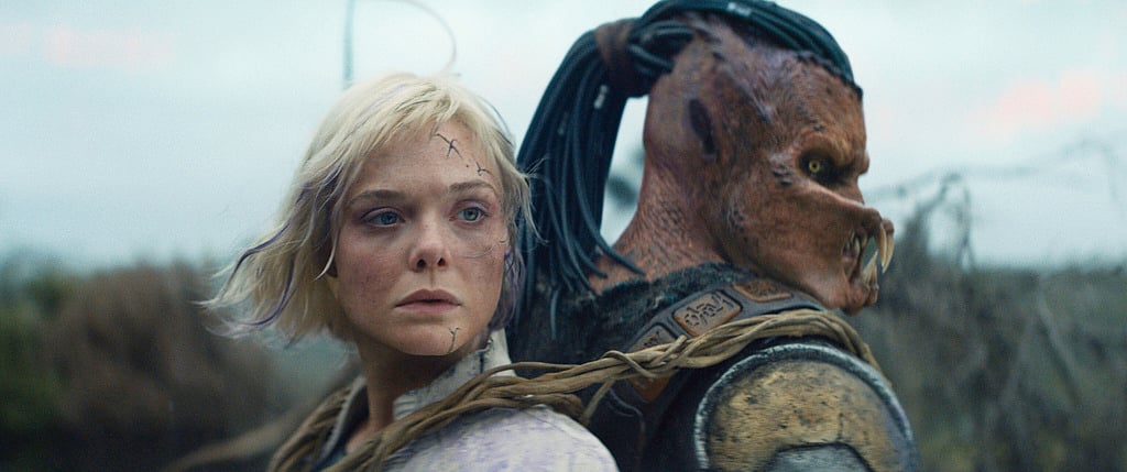 This image released by 20th Century Studios shows Thia, portrayed by Elle Fanning, left, and Dek, portrayed by Dimitrius Schuster-Koloamatangi, in a scene from "Predator: Badlands." (20th Century Studios/Disney via AP)