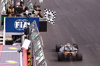 The checkered flag is waved as McLaren driver Lando Norris of Britain crosses the finish line to win the Brazilian Formula One Grand Prix at the Interlagos race track in Sao Paulo, Sunday, Nov. 9, 2025.