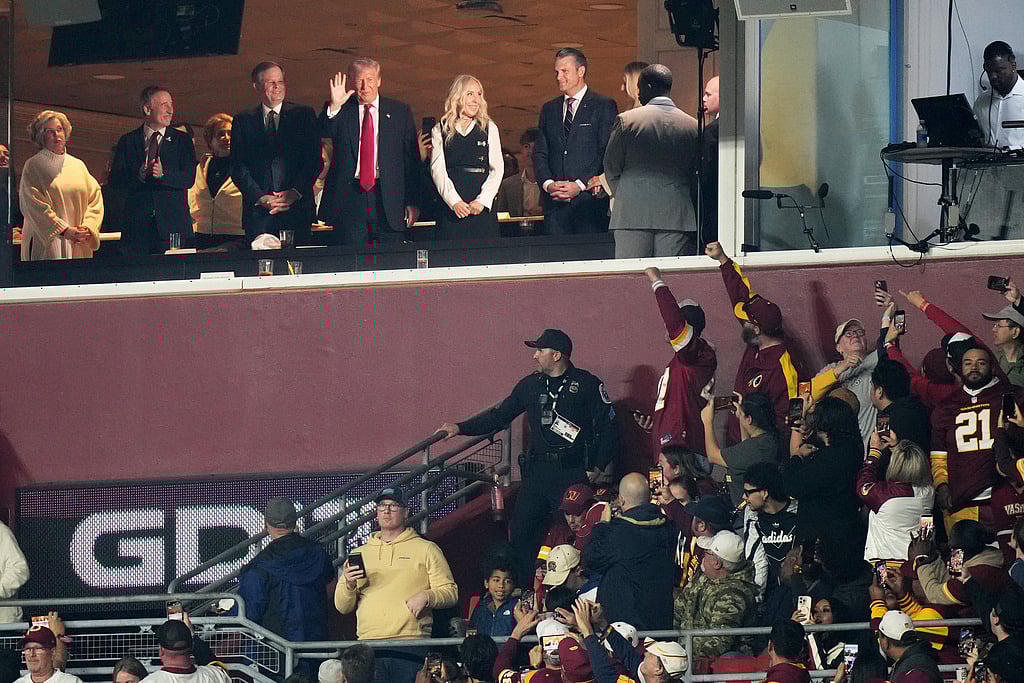 President Donald Trump is seen in a suite during the first half of an NFL football game between the Washington Commanders and the Detroit Lions Sunday, Nov. 9, 2025, in Landover, Md. (AP Photo/Stephanie Scarbrough)
