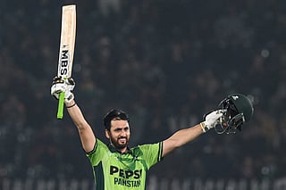 Pakistan's Salman Agha celebrates after scoring a century (100 runs) during the first one-day international (ODI) cricket match between Pakistan and Sri Lanka at the Rawalpindi Cricket Stadium in Rawalpindi on November 11, 2025.