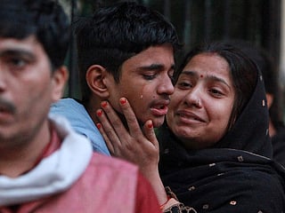 Family members of a car explosion victim break down in grief as they arrive at a New Delhi hospital mortuary to collect the body, a day after the deadly blast near the Red Fort Metro Station left the city mourning.