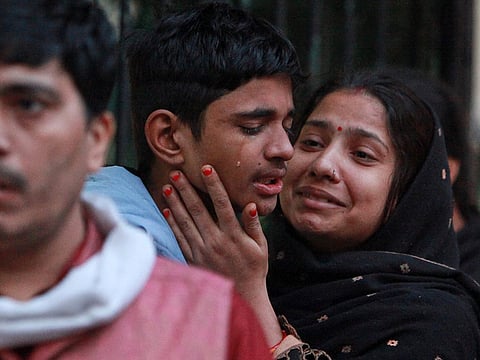 Family members of a car explosion victim break down in grief as they arrive at a New Delhi hospital mortuary to collect the body, a day after the deadly blast near the Red Fort Metro Station left the city mourning.