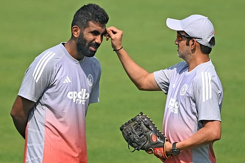 India’s coach Gautam Gambhir (R) and Jasprit Bumrah interact during a practice session ahead of their first Test cricket match against South Africa, at the Eden Gardens in Kolkata on November 11, 2025.