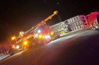 This photo provided by Mario Sanchez shows a bus that was carrying teens and young adults returning from a church camp overturned after it lost control and tipped onto its side on a two-lane highway Sunday, Nov. 9, 2025, near Running Springs, California.