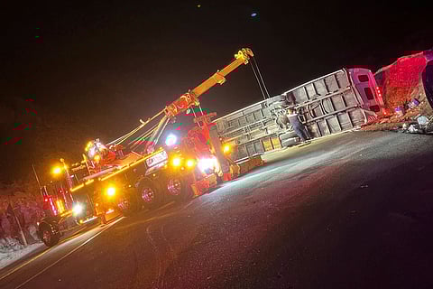 This photo provided by Mario Sanchez shows a bus that was carrying teens and young adults returning from a church camp overturned after it lost control and tipped onto its side on a two-lane highway Sunday, Nov. 9, 2025, near Running Springs, California.
