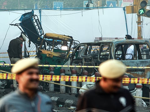 NSG commandos and Delhi Police personnel inspect the site where a car exploded near Gate No. 1 of the Red Fort Metro Station on Tuesday, as forensic teams search for evidence after the deadly blast.