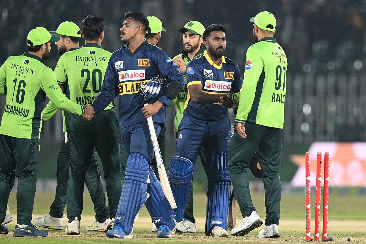 Sri Lanka's Maheesh Theekshana (CL) and Sri Lanka's Asitha Fernando (CR) shake hands with Pakistan's players at the end of the first one-day international (ODI) cricket match between Pakistan and Sri Lanka at the Rawalpindi Cricket Stadium in Rawalpindi on November 11, 2025.