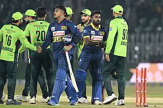 Sri Lanka's Maheesh Theekshana (CL) and Sri Lanka's Asitha Fernando (CR) shake hands with Pakistan's players at the end of the first one-day international (ODI) cricket match between Pakistan and Sri Lanka at the Rawalpindi Cricket Stadium in Rawalpindi on November 11, 2025.