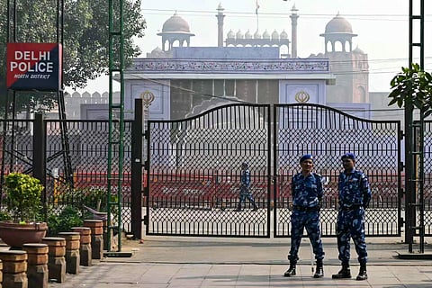 Rapid action force personnel stand guard near the blast site, after an explosion in the Red Fort area in the old quarters of Delhi, on November 12, 2025.