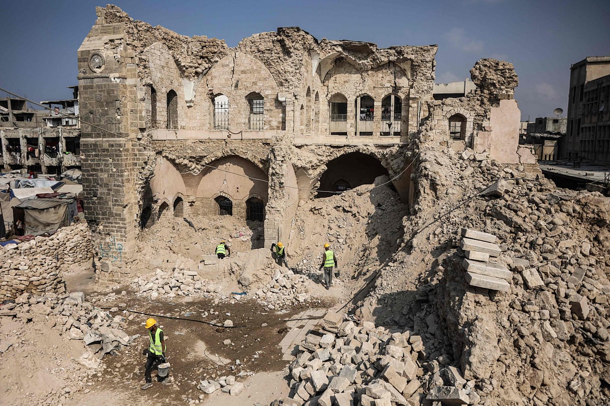 Workers start the rehabilitation on what remains of the Pasha Palace Museum, damaged by two years of fighting between Israel and Hamas, in Gaza City on November 11, 2025.