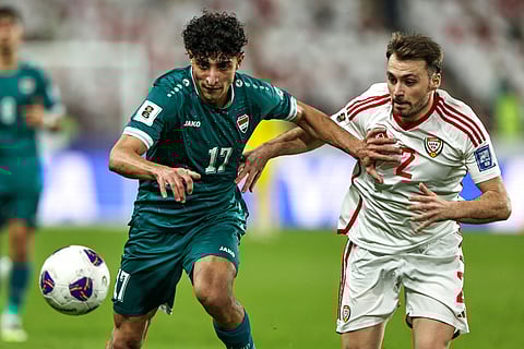 Iraq's midfielder #17 Ali Jasim vies for the ball with UAE's defender #2 Ruben Canedo during the FIFA World Cup 2026 Asian qualifier football match between the United Arab Emirates and Iraq at the Mohammed bin Zayed Stadium in Abu Dhabi on November 13, 2025.