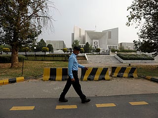 A policeman walks past the Supreme Court building in Islamabad, Pakistan. 