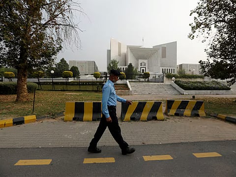 A policeman walks past the Supreme Court building in Islamabad, Pakistan. 