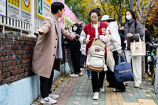 Students arrive for the annual college entrance exam, known locally as Suneung, outside the Gwangnam High School in Seoul on November 13, 2025.