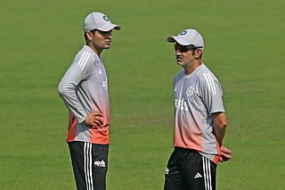 India’s captain Shubman Gill (L) and head coach Gautam Gambhir interact during a practice session on the eve of their first Test cricket match against South Africa, at the Eden Gardens in Kolkata on November 13, 2025.