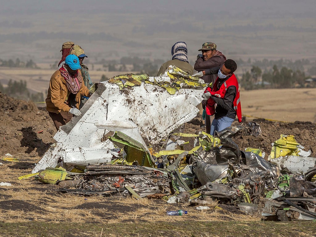 FILE - In this March 11, 2019, file photo, rescuers work at the scene of an Ethiopian Airlines flight crash near Bishoftu, Ethiopia. Pilot Bernd Kai von Hoesslin pleaded with his bosses for more training on the Boeing Max, just weeks before the Ethiopian Airline's jet crashed, killing everyone on board. 