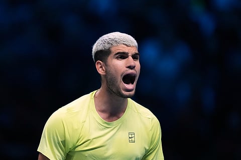 Spain's Carlos Alcaraz celebrates after winning against Italy's Lorenzo Musetti during the tennis match of the ATP World Tour Finals, in Turin, Italy, Thursday, Nov. 13, 2025. (AP Photo/Antonio Calanni)