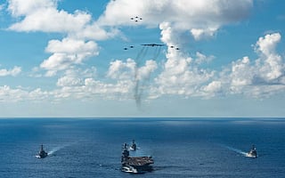 In this handout provided by the U.S. Navy, The U.S. Navy's Gerald R. Ford Carrier Strike Group, including the flagship USS Gerald R. Ford (CVN 78), front, USS Winston S. Churchill (DDG 81), right, USS Mahan (DDG 72), left, USS Bainbridge (DDG 96), and embarked Carrier Air Wing Eight F/A-18E/F Super Hornets assigned to Strike Fighter Squadrons 31, 37, 87, and 213, operates as a joint, multi-domain force with a U.S. Air Force B-52 Stratofortress. File photo taken on November 13, 2025.