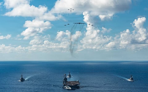 In this handout provided by the U.S. Navy, The U.S. Navy's Gerald R. Ford Carrier Strike Group, including the flagship USS Gerald R. Ford (CVN 78), front, USS Winston S. Churchill (DDG 81), right, USS Mahan (DDG 72), left, USS Bainbridge (DDG 96), and embarked Carrier Air Wing Eight F/A-18E/F Super Hornets assigned to Strike Fighter Squadrons 31, 37, 87, and 213, operates as a joint, multi-domain force with a U.S. Air Force B-52 Stratofortress. File photo taken on November 13, 2025.