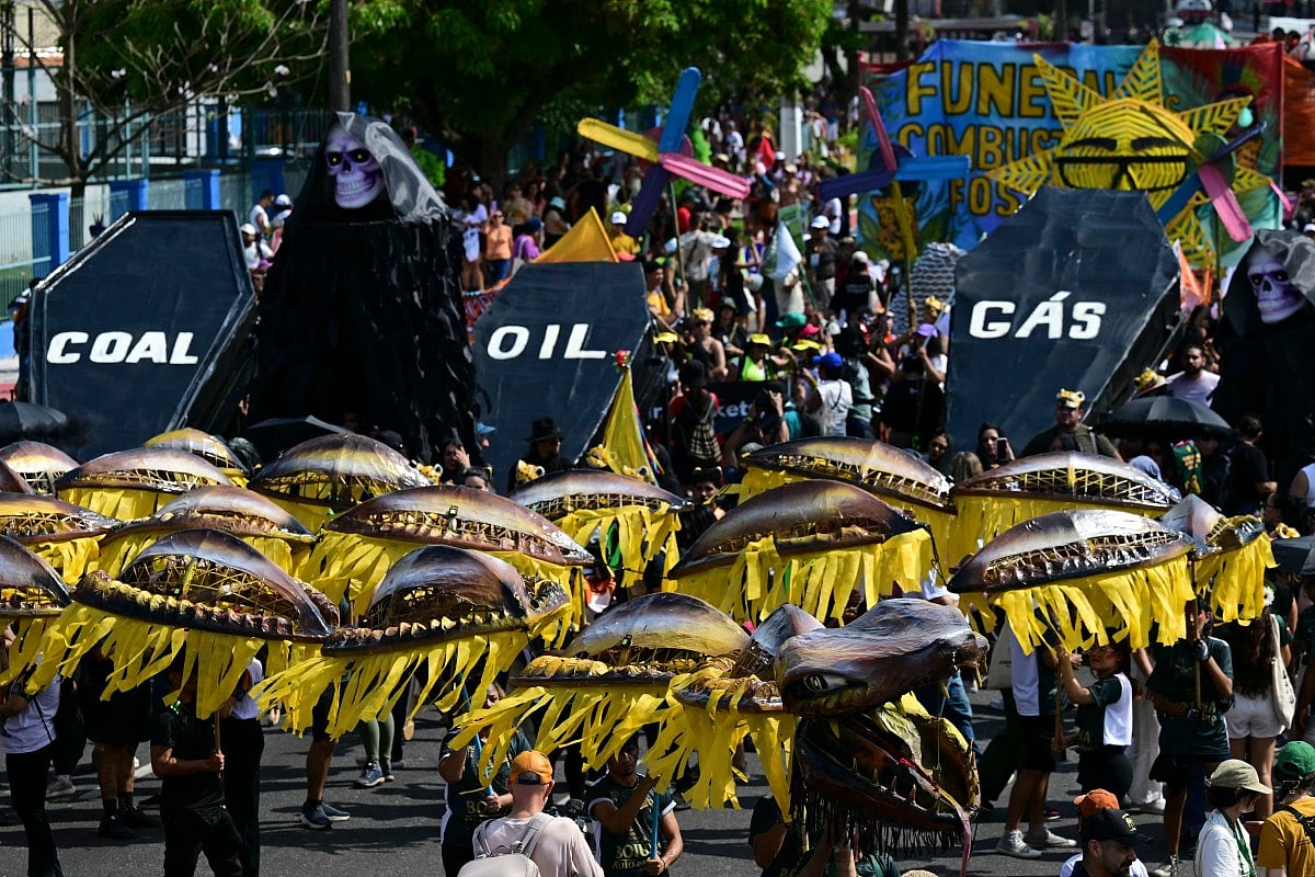 Activists perform the death of fossil fuels at the so-called "Great People's March" in the sidelines of the COP30 UN Climate Change Conference in Belem, Para State, Brazil. File photo taken on November 15, 2025.