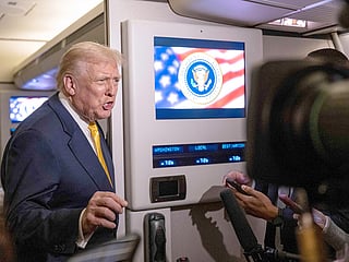 US President Donald Trump speaks to members of press aboard Air Force One on November 14, 2025 while in flight from Washington, DC to West Palm Beach International Airport. 