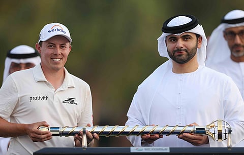 Sheikh Mansoor Bin Mohammed Bin Rashid Al Maktoum hands over the trophy to Matt Fitzpatrick on Sunday.