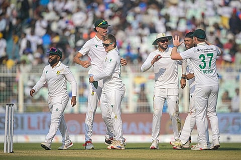 South Africa's players celebrate their team's win against India at the end of their first Test cricket match in the Eden Gardens of Kolkata on November 16, 2025.
