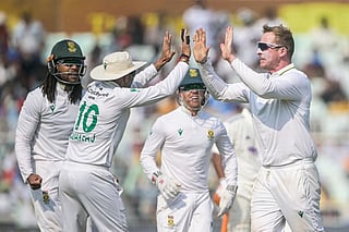 South Africa's Simon Harmer (R) celebrates with teammates after taking the wicket of India's Rishabh Pant during the third day of the first Test cricket match at the Eden Gardens in Kolkata on November 16, 2025.