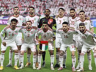UAE players stand for a group picture ahead of the FIFA World Cup 2026 Asian qualifier football match against Iraq at the Mohammed bin Zayed Stadium in Abu Dhabi on November 13, 2025. 